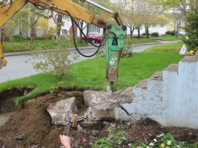 Rock Hammer on backhoe breaking old step